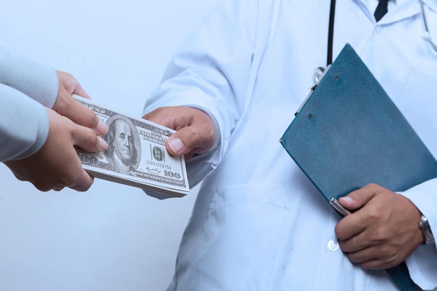 patient-s-hand-paying-money-to-doctor-2